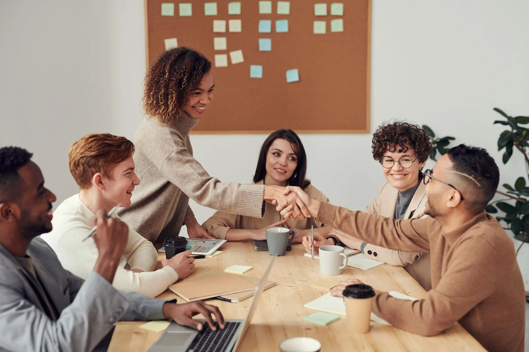 Business team collaborating around an office table — illustrative photograph