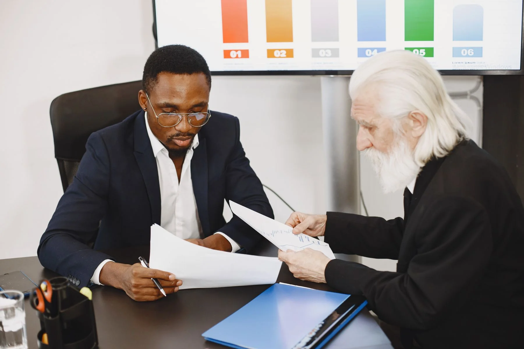 Two professionals discussing written plans — illustrative photograph