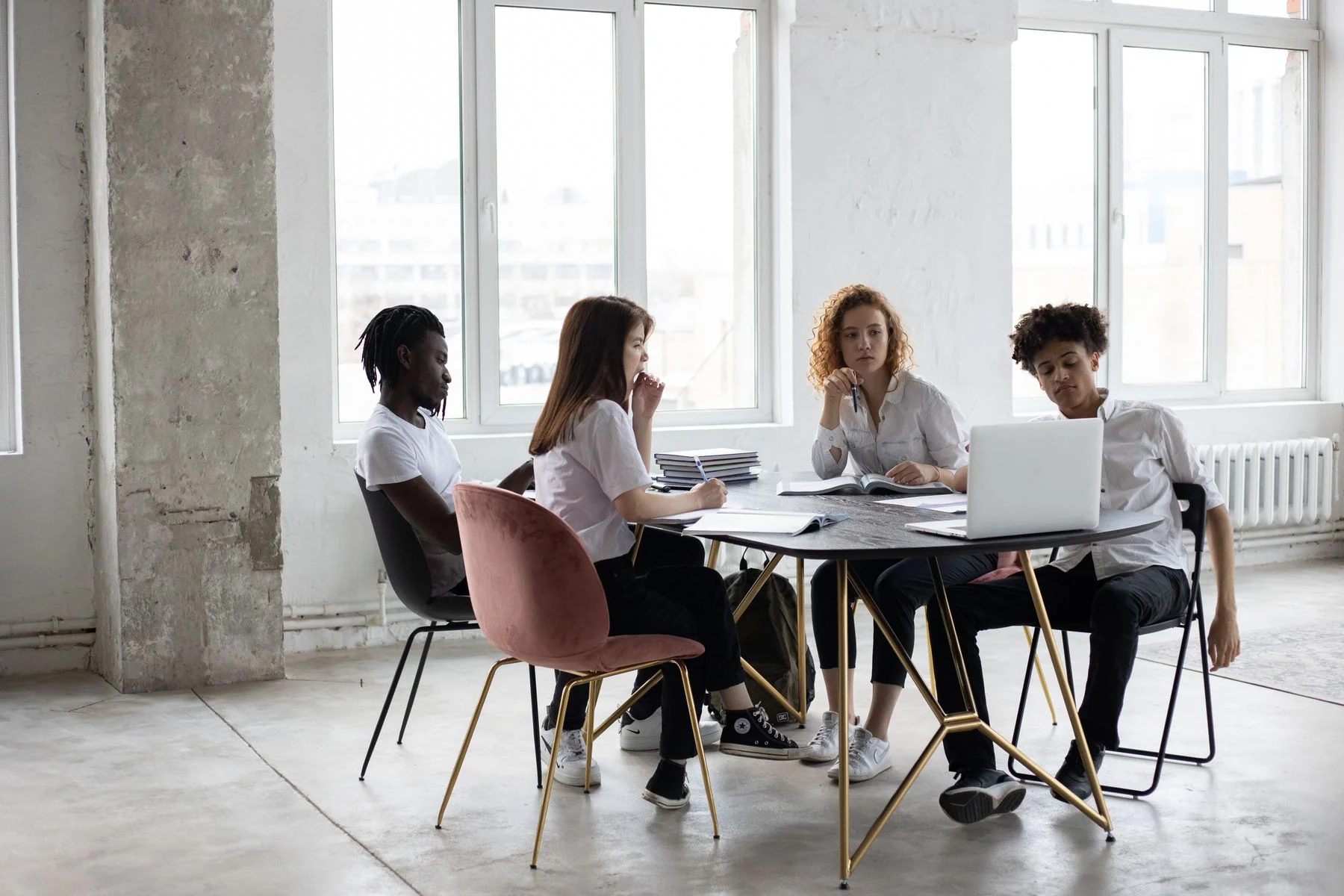 Colleagues reviewing a project around an office table