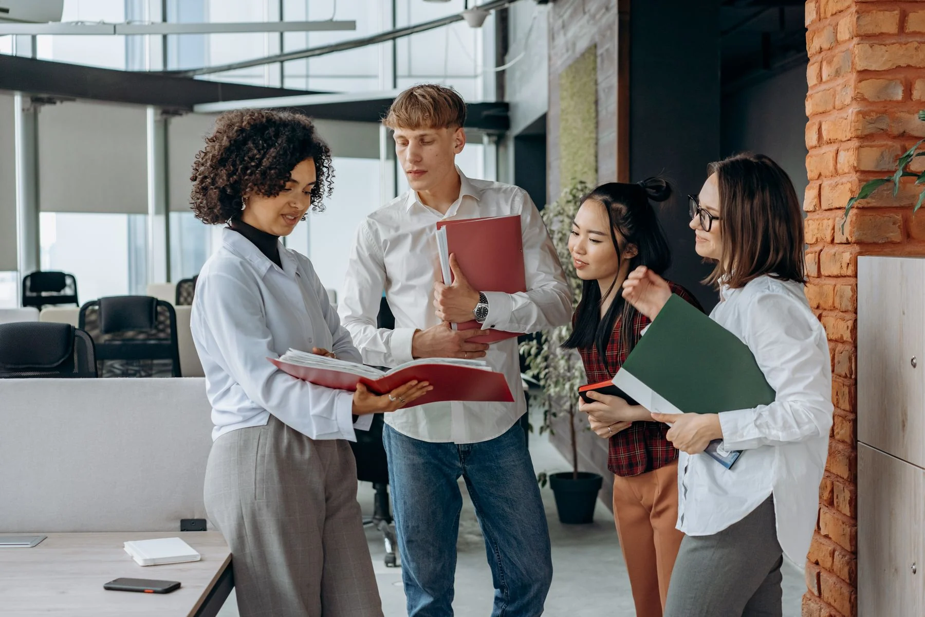 Colleagues discussing documents in an office
