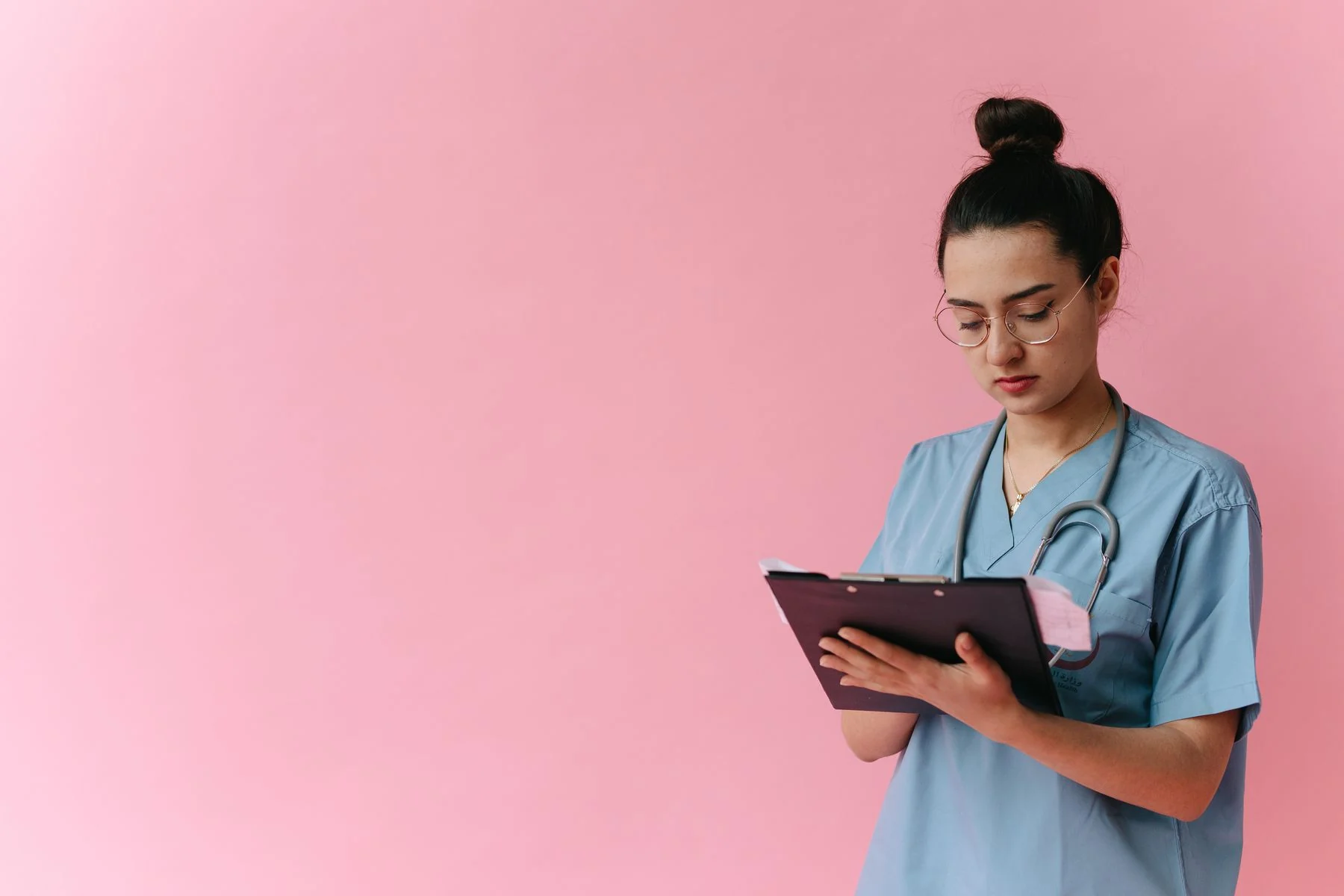 Healthcare professional reviewing a clipboard