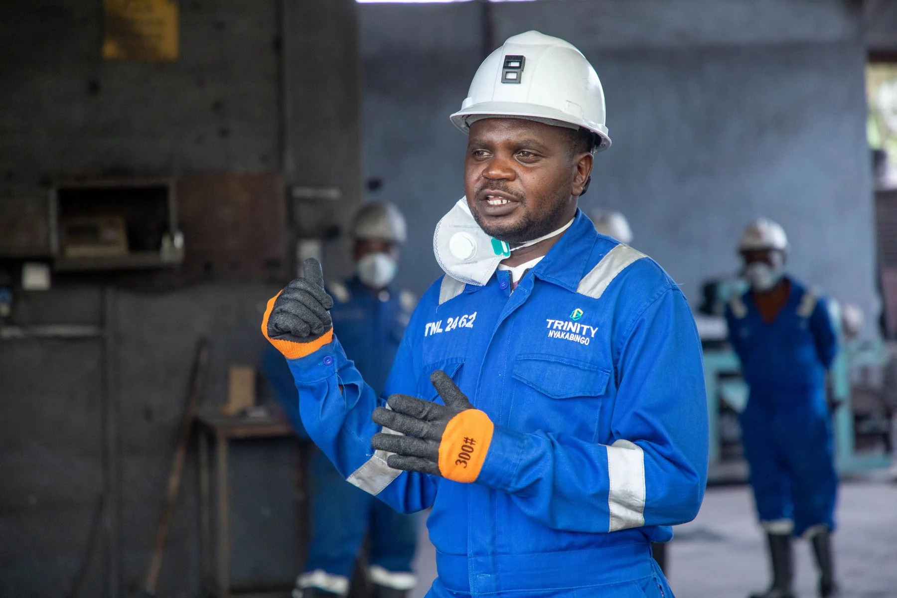 Industrial worker discussing safety procedures in protective equipment