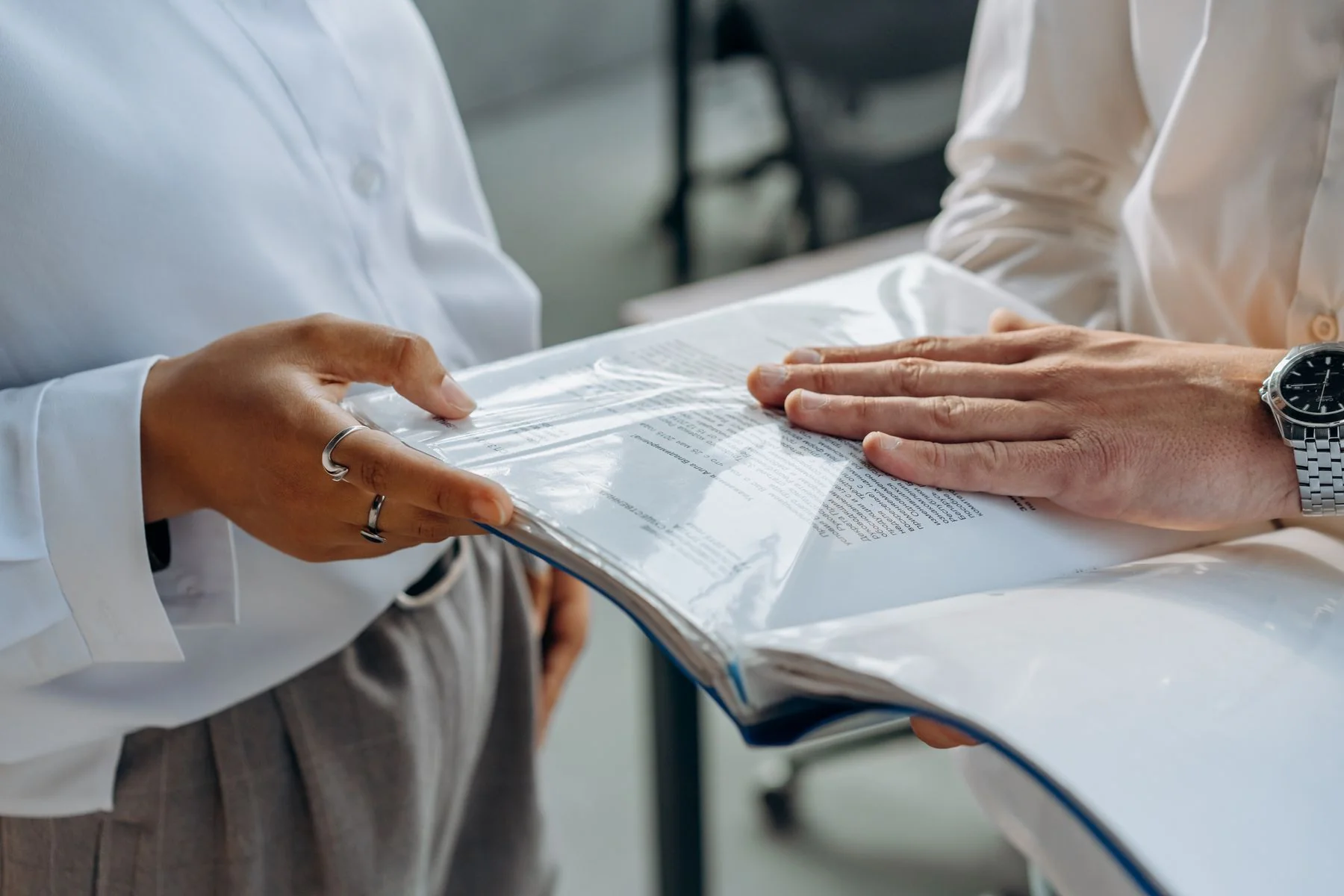 Colleagues reviewing documents together — illustrative photograph
