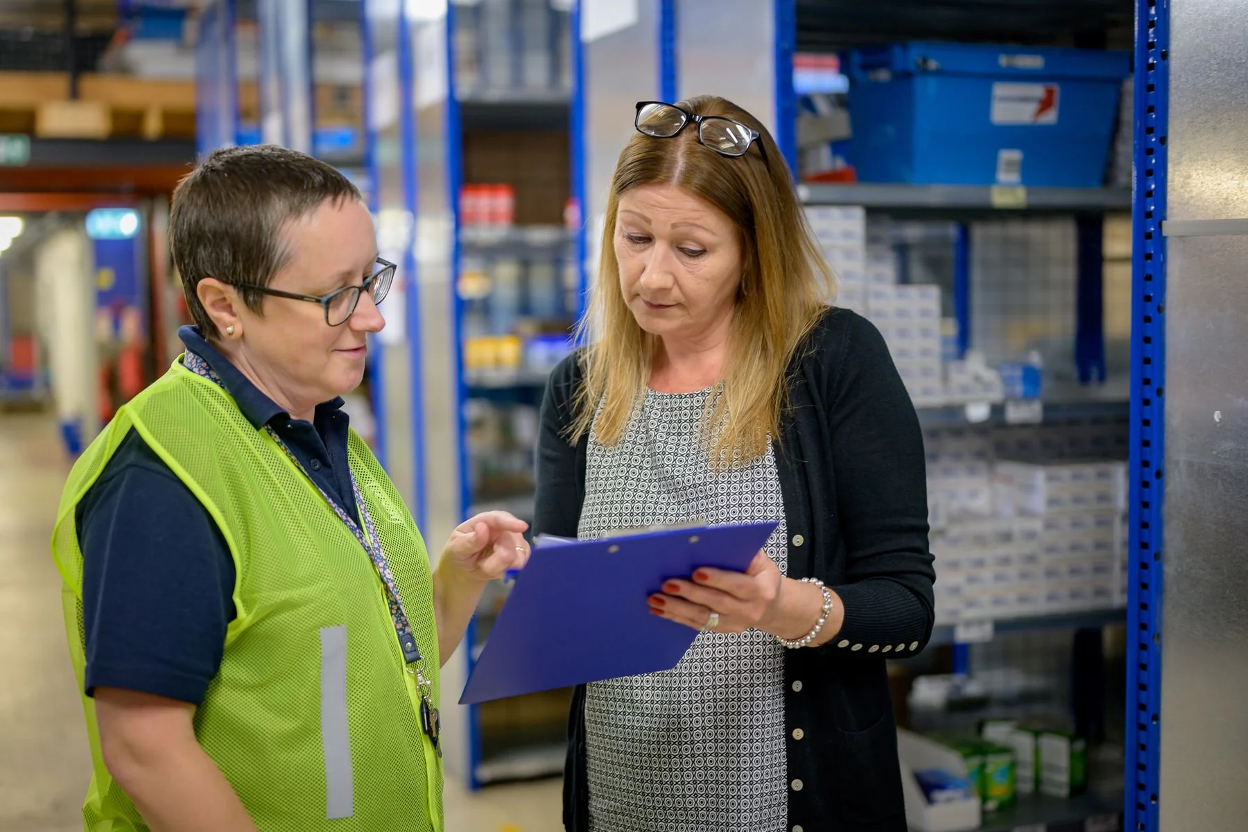 Warehouse colleagues reviewing a clipboard